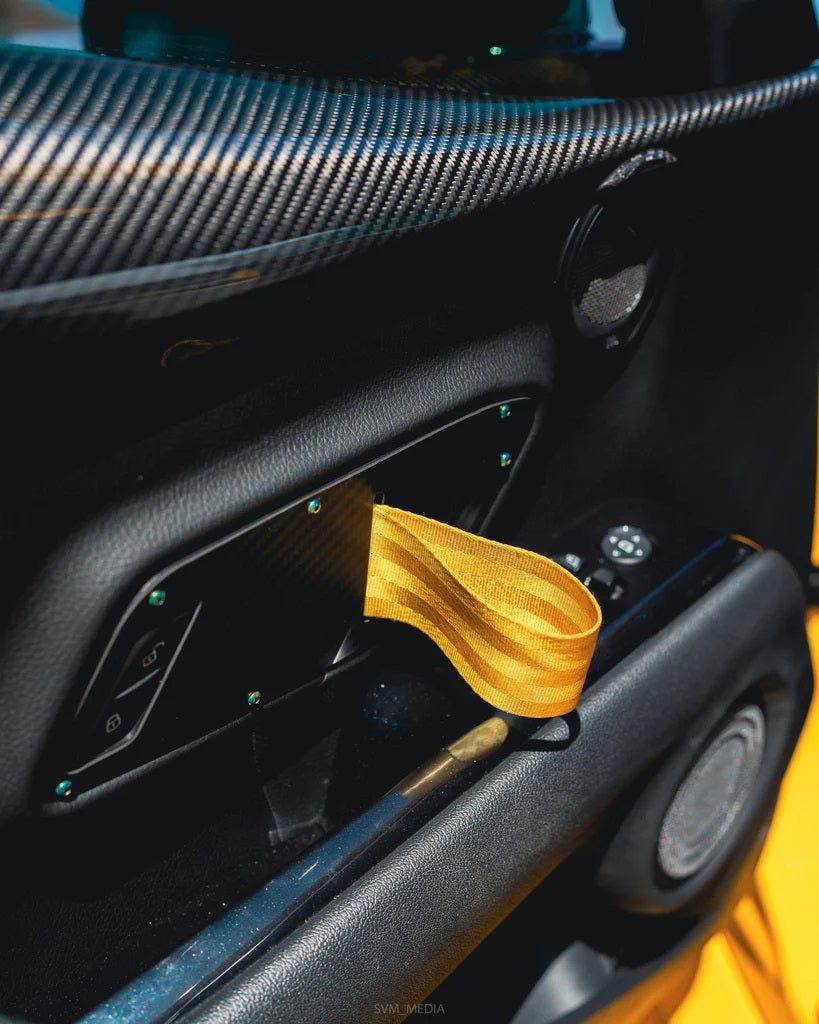 Supra GT door pull with a gold strap